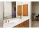 Double vanity bathroom with light wood cabinets and brushed gold fixtures at 15972 N 115Th Way, Scottsdale, AZ 85255