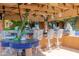 Poolside bar with unique decor and seating for entertaining at 15972 N 115Th Way, Scottsdale, AZ 85255