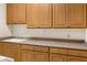 Laundry room with light wood cabinets and a built in sink at 15972 N 115Th Way, Scottsdale, AZ 85255