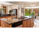 Island kitchen with granite countertops and stainless steel appliances at 15972 N 115Th Way, Scottsdale, AZ 85255