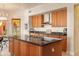 Kitchen boasts granite countertops, wood cabinets, and stainless steel appliances at 15972 N 115Th Way, Scottsdale, AZ 85255
