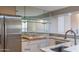 Modern kitchen with stainless steel appliances and granite counters at 15972 N 115Th Way, Scottsdale, AZ 85255