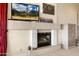 Living room fireplace with built-in shelving and tv at 15972 N 115Th Way, Scottsdale, AZ 85255