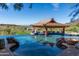 Infinity pool with a built-in bar and stunning panoramic mountain views at 15972 N 115Th Way, Scottsdale, AZ 85255