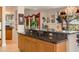 Kitchen features a granite breakfast bar and views to the backyard at 15972 N 115Th Way, Scottsdale, AZ 85255