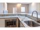 Modern kitchen features granite countertops, stainless steel sink and microwave at 15972 N 115Th Way, Scottsdale, AZ 85255