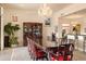 Elegant dining room features a large table with intricate chairs, a beautiful chandelier, and a stunning display cabinet at 15972 N 115Th Way, Scottsdale, AZ 85255