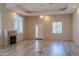 Spacious living room with hardwood floors, fireplace and chandelier at 15972 N 115Th Way, Scottsdale, AZ 85255
