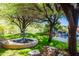 Lush backyard with a fountain, waterfall, and tranquil pool area at 15972 N 115Th Way, Scottsdale, AZ 85255