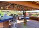 Covered patio bar with seating, adjacent to the pool at 15972 N 115Th Way, Scottsdale, AZ 85255