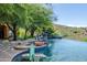 Expansive resort-style pool with a spa, waterfall and basketball hoop at 15972 N 115Th Way, Scottsdale, AZ 85255
