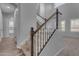 Elegant staircase with dark wood railing and neutral carpeting at 2452 E Aloe Pl, Chandler, AZ 85286