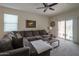 Living room with sectional sofa and access to backyard patio at 17078 N Rosemont St, Maricopa, AZ 85138