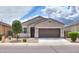 Charming one-story home with a brown garage door and well-manicured front yard at 17078 N Rosemont St, Maricopa, AZ 85138