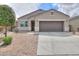 One-story house with a brown garage door and a small front yard at 17078 N Rosemont St, Maricopa, AZ 85138