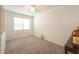 Cozy carpeted bedroom with a window and neutral-colored walls at 17078 N Rosemont St, Maricopa, AZ 85138