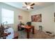 Home office with large desk, comfortable chair, and artwork at 17078 N Rosemont St, Maricopa, AZ 85138
