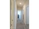 Bright hallway with neutral carpeting and access to bedrooms at 17078 N Rosemont St, Maricopa, AZ 85138