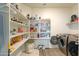 Laundry room with washer, dryer, and built-in shelving at 17078 N Rosemont St, Maricopa, AZ 85138