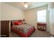 Bedroom with queen-size bed and accent table at 17078 N Rosemont St, Maricopa, AZ 85138
