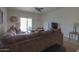 Spacious living room with large sectional sofa and sliding glass door at 17078 N Rosemont St, Maricopa, AZ 85138