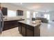 Modern kitchen with granite countertops and dark brown cabinets at 17078 N Rosemont St, Maricopa, AZ 85138