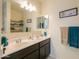 Bathroom with double vanity and linen storage at 17078 N Rosemont St, Maricopa, AZ 85138