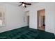 Green carpeted bedroom with ceiling fan and ensuite bathroom at 5415 E Mckellips Rd # 56, Mesa, AZ 85215