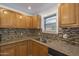 Kitchen with wood cabinets, granite countertops, and tile backsplash at 1916 E Clarendon Ave, Phoenix, AZ 85016