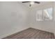 Well-lit bedroom featuring window blinds and wood-look floors at 18202 Cave Creek Rd # 129, Phoenix, AZ 85032