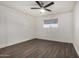 Spacious bedroom with ceiling fan and dark gray vinyl flooring at 18202 Cave Creek Rd # 129, Phoenix, AZ 85032