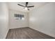 Bright bedroom with wood-look floors and ceiling fan at 18202 Cave Creek Rd # 111, Phoenix, AZ 85032