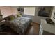 Bedroom with gray bedding and wood floors at 4065 E University Dr # 300, Mesa, AZ 85205