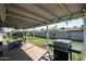 Covered patio with dining area and grill at 8833 W Monroe St, Peoria, AZ 85345