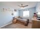 Light and bright bedroom with wood-toned furniture and ceiling fan at 8833 W Monroe St, Peoria, AZ 85345