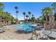 Inviting community pool with lounge chairs and patio table at 10030 W Indian School Rd # 218, Phoenix, AZ 85037