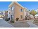 Exterior view of a corner condo unit with stairs and landscaping at 10030 W Indian School Rd # 218, Phoenix, AZ 85037