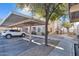 Covered parking area with a walkway and building view at 10030 W Indian School Rd # 218, Phoenix, AZ 85037