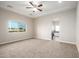 Spacious bedroom with carpet flooring and ceiling fan at 29785 N 203Rd Dr, Wittmann, AZ 85361