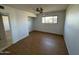 Bright bedroom featuring wood-look floors and ceiling fan at 3023 W Larkspur Dr, Phoenix, AZ 85029