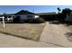 Ranch style home with green trim, single car garage and driveway at 3023 W Larkspur Dr, Phoenix, AZ 85029