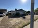 Ranch style home with green trim, single car garage and driveway at 3023 W Larkspur Dr, Phoenix, AZ 85029