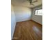 Spacious bedroom with wood-look floors and ceiling fan at 3023 W Larkspur Dr, Phoenix, AZ 85029