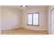 Bright bedroom with wood floors and large window at 43630 N 20Th St, New River, AZ 85087