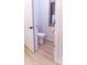 Small half bathroom with toilet and wood-look flooring at 43630 N 20Th St, New River, AZ 85087