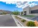 Modern home with stone exterior, landscaping, and a mountain view in the background at 9626 S 7Th Pl, Phoenix, AZ 85042