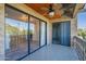 Private balcony with glass sliding doors and view of the living room at 4950 N Miller Rd # 233, Scottsdale, AZ 85251