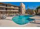 Community pool with ample lounge chairs and patio furniture at 4950 N Miller Rd # 233, Scottsdale, AZ 85251