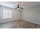 Charming bedroom with wood-look floors, plantation shutters, and ceiling fan at 4950 N Miller Rd # 233, Scottsdale, AZ 85251