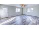 Bright living room featuring wood-look floors and sliding glass door at 19409 N 45Th Dr, Glendale, AZ 85308